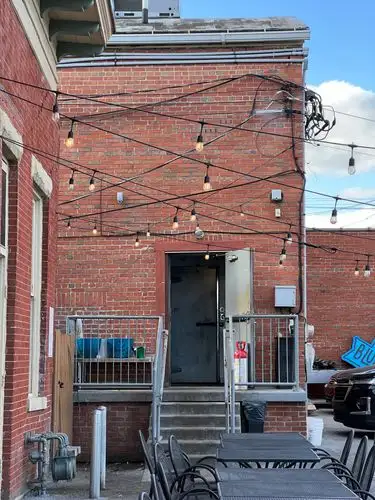 Cozy brick patio vibes under twinkling lights.
